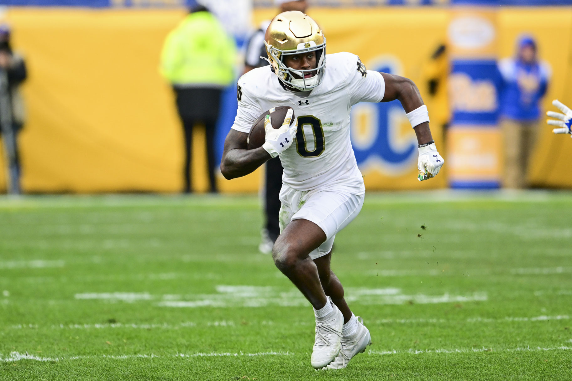 Malachi Fields, #0 of the Notre Dame Fighting Irish, running with the football during a game.