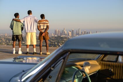 The cast of Bel Air Jazz (Jordan L. Jones), Will (Jabari Banks), and Carlton (Olly Sholotan) standing and looking at the view of Los Angeles