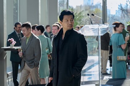 Alexander (Simu Liu) wears a coat at an event on The Copenhagen Test Season 1.