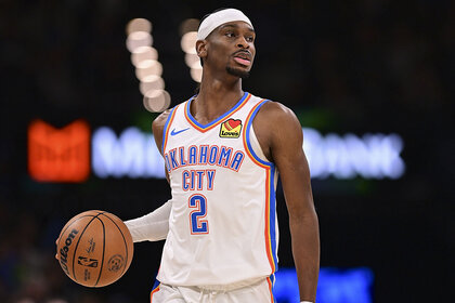 Shai Gilgeous-Alexander, #2 of the Oklahoma City Thunder, holding a basketball during a game against the Utah Jazz.