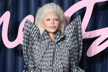 Lisa Rinna wearing a blonde wig and a black and white structural dress with high shoulders