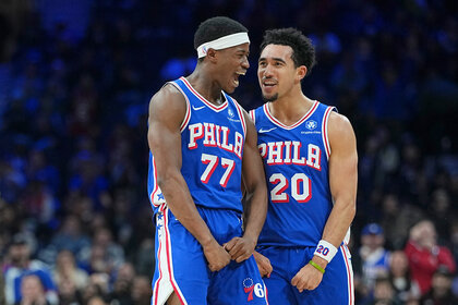 Vj Edgecombe of the Philadelphia 76ers celebrates with Jared McCain against the Milwaukee Bucks.
