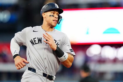 Aaron Judge of the New York Yankees runs to first after hitting a one-run single in the seventh inning during Game Two of the American League Division Series between the New York Yankees and the Toronto Blue Jays.