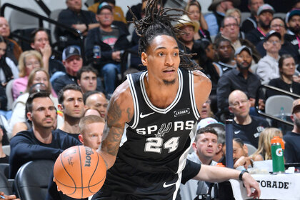 Devin Vassell of the San Antonio Spurs handles the ball during the game against the Denver Nuggets.