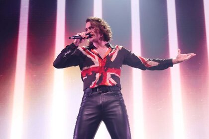 Aidan singing on stage during the London Eurovision Party 2026.