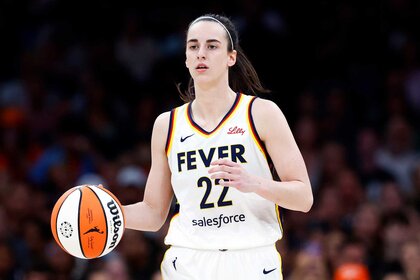 Caitlin Clark of Indiana Fever dribbles during the first quarter of a game.