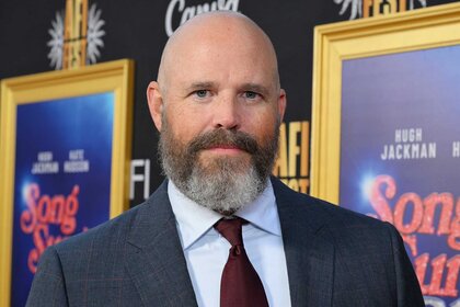 David Denman smiling and posing in a suit during the Screening of Song Sung Blue during AFI FEST 2025.