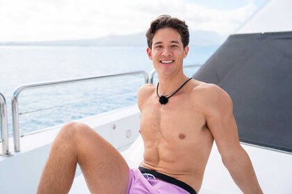Carl Schmidt sitting on a boat on Love Island USA Season 8 Episode 18.