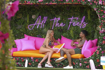Mackenzie "Kenzie" Brooke Annis and Sean David Reifel sitting and talking in Love Island USA Season 8 Episode 2.