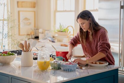Hollis making breakfast in her kitchen in The Five Star Weekend Season 1.