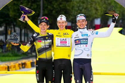 Jonas Vingegaard, Tadej Pogacar, and Florian Lipowitz celebrating and holding trophies at the Tour de France 2025.