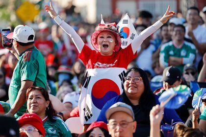 A South Korea fan cheering amongst other fans during the World Cup match between the two countries South Korea and Mexico.