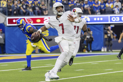Jacoby Brissett, Arizona Cardinals Quarterback #7, preparing to throw a ball during a game.