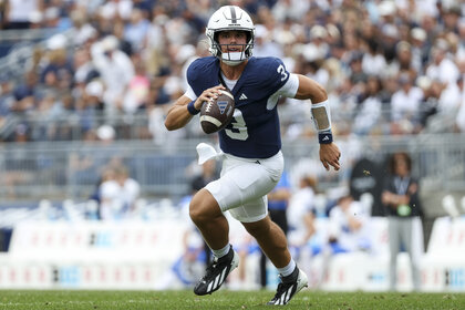 Rocco Becht, #3 of the Penn State Nittany Lions, running with the ball during a game.