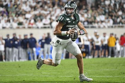 Quarterback Alessio Milivojevic, #11 of the Michigan State Spartans, running with the football during a game.