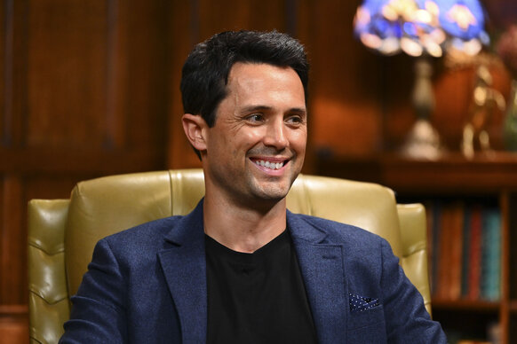 Stephen Colletti smiling while sitting in The Traitors Season 4 Episode 1.
