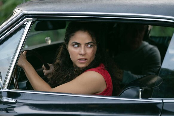 Etta looking back in a car in M.I.A. Season 1.