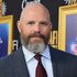 David Denman smiling and posing in a suit during the Screening of Song Sung Blue during AFI FEST 2025.