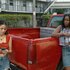 Etta and Lovely leaning against a red truck in M.I.A. Season 1.
