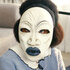 Romy Woods wearing a white mask during the film Strung (2026).