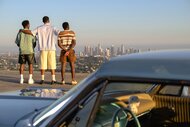 The cast of Bel Air Jazz (Jordan L. Jones), Will (Jabari Banks), and Carlton (Olly Sholotan) standing and looking at the view of Los Angeles