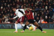 Antoine Semenyo of AFC Bournemouth is challenged by Gabriel Magalhães of Arsenal during a football match.
