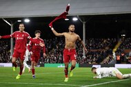Cody Gakpo of Liverpool celebrates scoring his team's second goal with teammates Virgil van Dijk and Milos Kerkez.