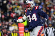 New England Patriots defensive tackle Cory Durden celebrates a tackle in the second quarter on the field.