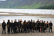 The cast of The Traitors Season 4 in front of a river on a mountain side.