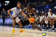 North Carolina A&T Aggies Guard Jahnathan Lamothe, #5, dribbles the ball against the Hofstra Pride.