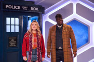 Aimee Lou Wood and Hammed Animashaun in front of a police station set.