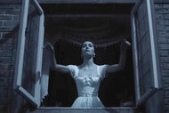 Lily Rose Depp as Ellen Hutler standing at an open window.