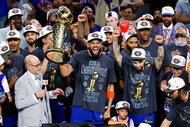Karl-Anthony Towns of the New York Knicks cheering and celebrating with the Larry O'Brien Championship Trophy after the victory against the San Antonio Spurs in Game Five of the 2026 NBA Finals.