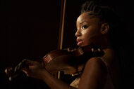 Laila (Chloe Bailey) playing a violin in Strung (2026).