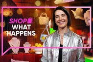 A woman smiling in front of a display of shoppable products surrounded by the Bravo talk bubble