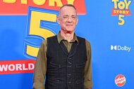 Tom Hanks smiling and posing at the premiere of Toy Story 5.