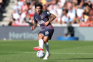 Sandro Tonali kicking a ball on a soccer field.