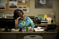 Donna Meagle (Retta) sitting behind a desk in Parks & Recreation Season 5 Episode 21.