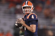 Katin Houser, #4 of the Illinois Fighting Illini, preparing to throw a football ahead of a game.
