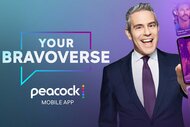 Andy Cohen smiles in a suit beside “Your Bravoverse” and Peacock Mobile App graphics while holding a smartphone displaying app content.