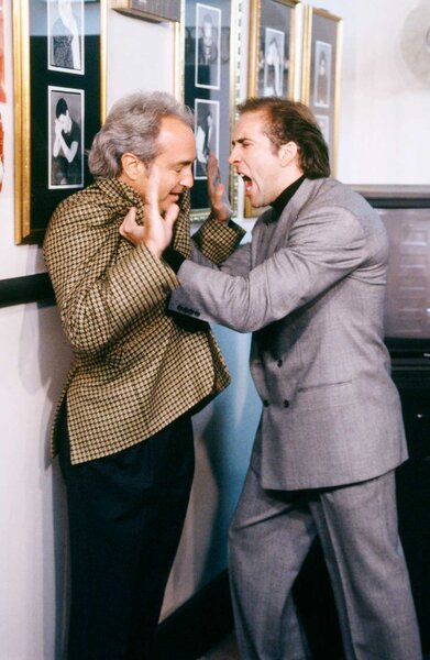 Nicolas Cage yelling at Lorne Michaels while pinning him against a wall during Saturday Night Live Season 18 Episode 1.