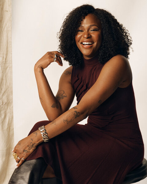 Ayoade Bamgboye posing in front of a cream backdrop.
