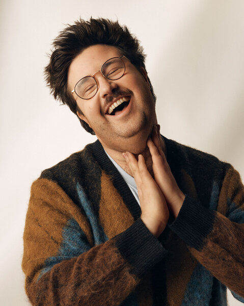 Al Nash posing in front of a cream backdrop.