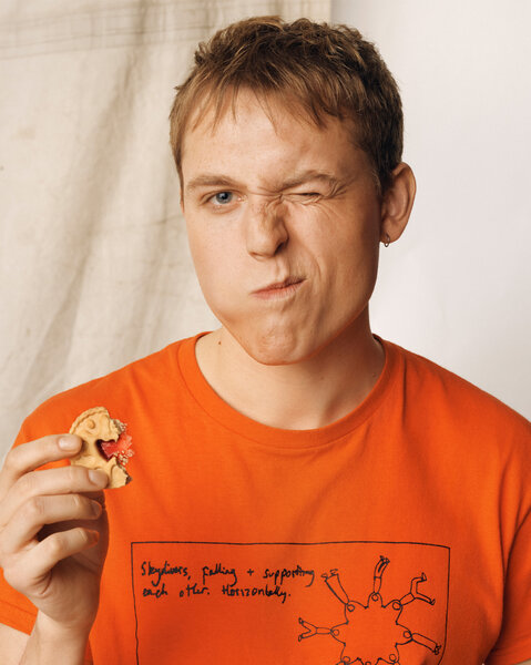 Jack Shep posing in front of a cream backdrop.