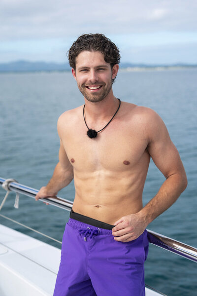 Dylan Wrona smiles on a boat in swim trunks in Love Island USA Season 8.