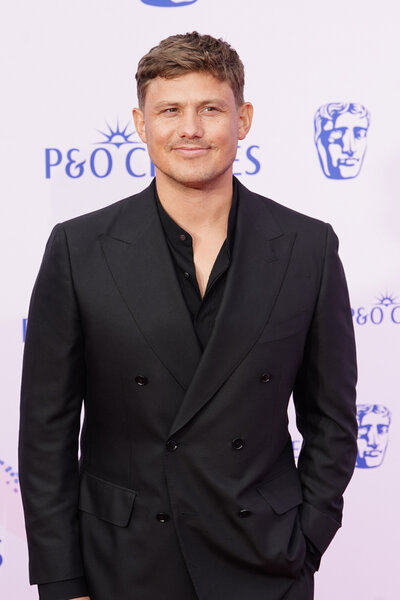 Jon Pointing poses in a black suit on the red carpet at the BAFTA TV Awards 2026.