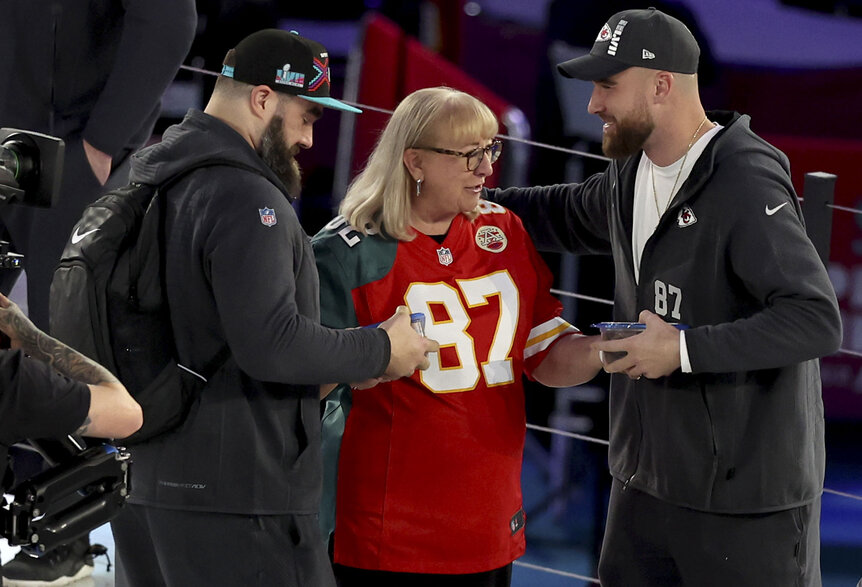 Donna Kelce gives cookies to her sons Jason Kelce and Travis Kelce ahead of a football game.