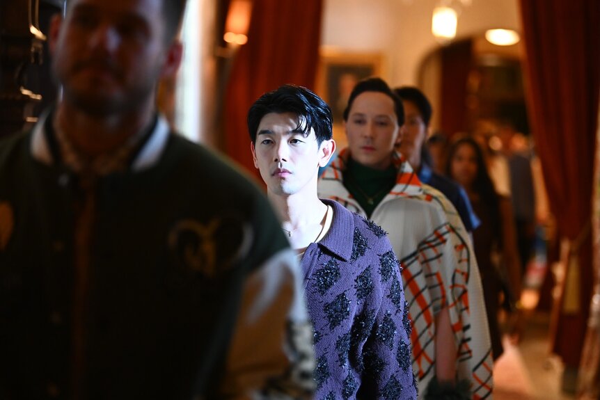 Eric Nam and Johnny Weir walk in a line on The Traitors Episode 402.