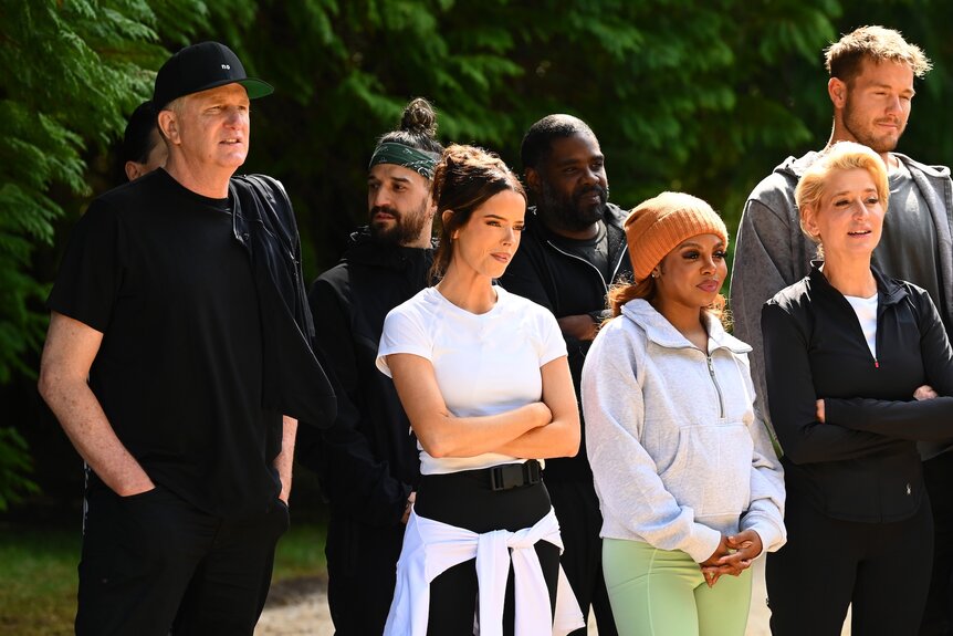 The cast stands outside on The Traitors Episode 405.