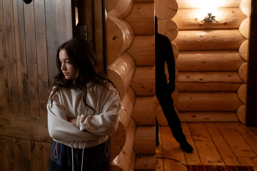 A dark figure hides behind a wall near Parker Mason (Gideon Adlon) in&nbsp;Sick (2022).